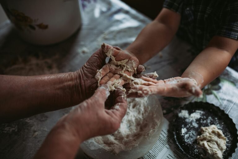 hands making sourdough. dough sticking to fingers.